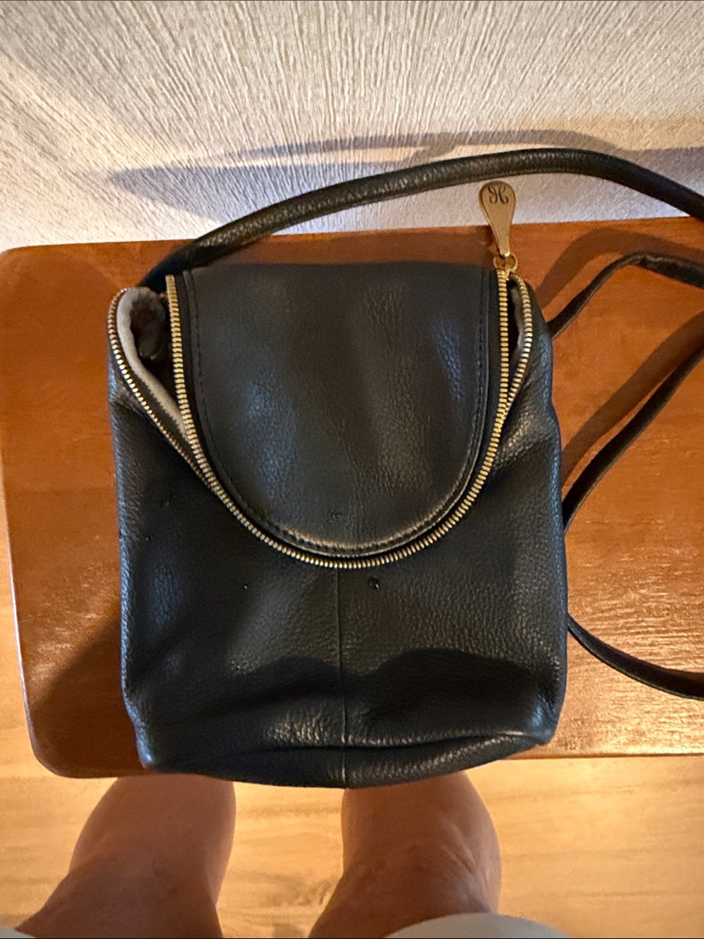 HOBO Black Leather Crossbody Bag with Gold Zip Accent